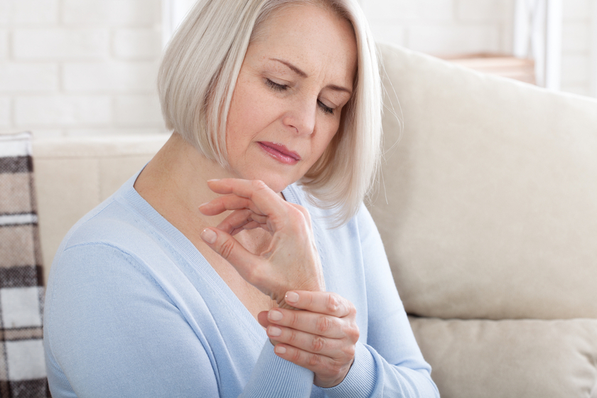 Woman massaging her arthritic hand and wrist