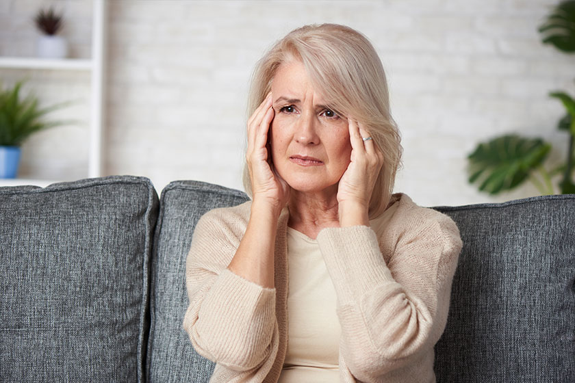 Senior woman suffering headache