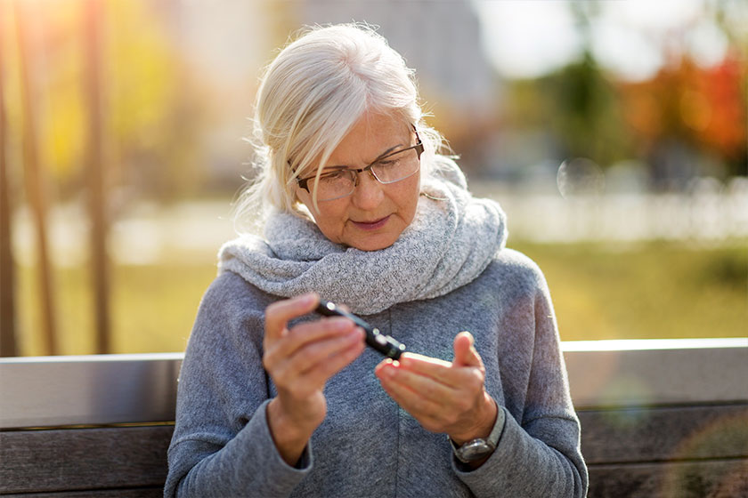 Woman checking blood sugar level