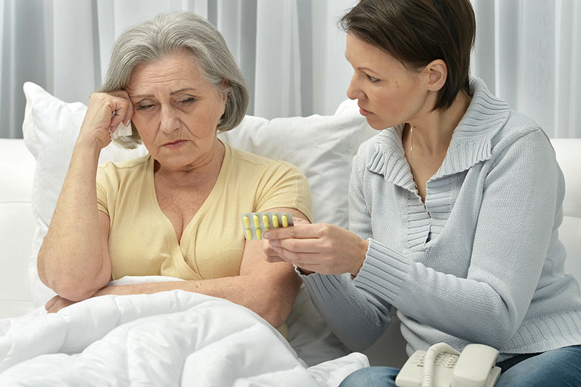 Woman taking care of ill woman